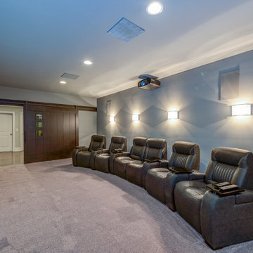 Home Theater with custom modern "Barn Door" which slides to wall for a wide entr