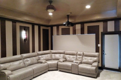 Medium sized modern enclosed home cinema in Houston with a projector screen.