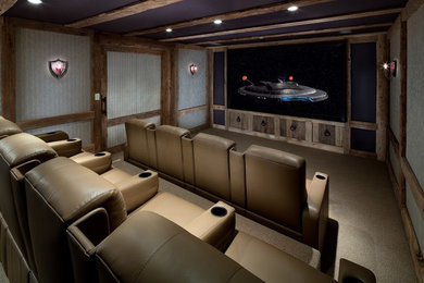 Large mountain style enclosed carpeted home theater photo in Orange County with gray walls and a projector screen