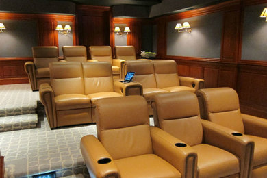 Minimalist enclosed carpeted home theater photo in New York with gray walls