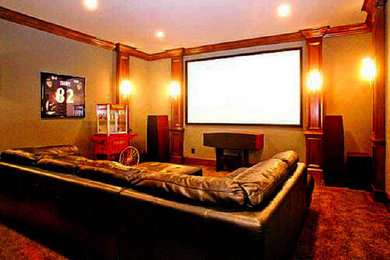 Large home theater photo in Atlanta with beige walls and a projector screen