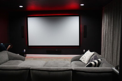 Inspiration for a transitional home theater remodel in Austin with a projector screen