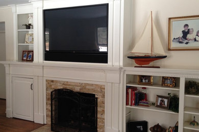 Minimalist medium tone wood floor home theater photo in Other with white walls and a media wall