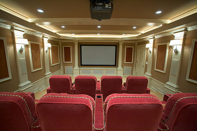Diseño de cine en casa cerrado tradicional grande con paredes marrones, moqueta y pantalla de proyección