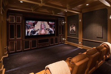 Large transitional enclosed carpeted and brown floor home theater photo in Atlanta with gray walls and a projector screen