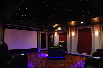 Photo of a medium sized classic enclosed home cinema in Boston with grey walls, carpet and a projector screen.