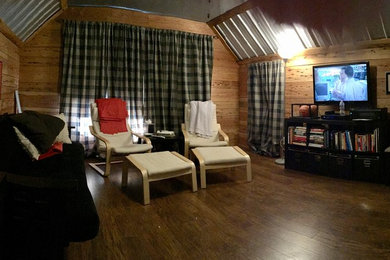 This is an example of a medium sized rustic home cinema in Atlanta.