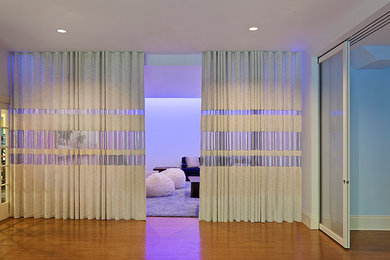 Ejemplo de cine en casa abierto moderno grande con paredes blancas, moqueta y pantalla de proyección