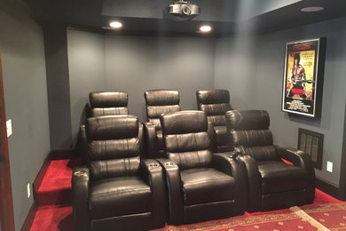 Inspiration for a mid-sized timeless enclosed carpeted and red floor home theater remodel in Atlanta with gray walls