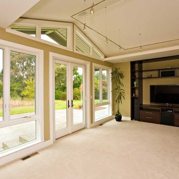 media room with vaulted ceiling and french doors