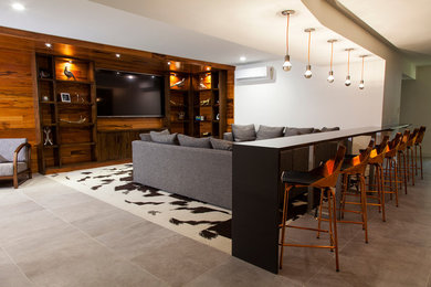 Example of a mid-sized minimalist open concept porcelain tile home theater design in Boston with white walls and a media wall