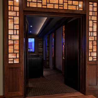 Home theater - huge contemporary enclosed carpeted home theater idea in Omaha with beige walls and a projector screen