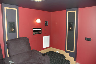 Large trendy enclosed carpeted home theater photo in Raleigh with red walls and a projector screen