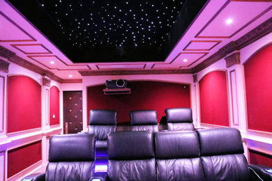 Design ideas for a medium sized modern enclosed home cinema in Boston with carpet and a projector screen.