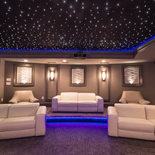 Home theater - large contemporary enclosed carpeted and gray floor home theater idea in Atlanta with gray walls and a projector screen