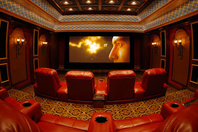 This is an example of a large retro enclosed home cinema in New York with red walls, carpet, a projector screen and brown floors.