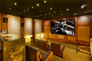 Example of a trendy enclosed home theater design in Orange County with a projector screen