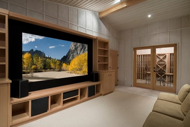 This is an example of a large modern open plan home cinema in Other with grey walls, carpet, a built-in media unit and beige floors.