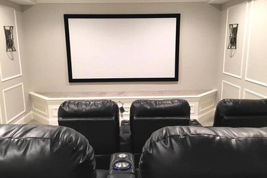 Foto de cine en casa cerrado tradicional grande con paredes grises, suelo de baldosas de porcelana, pantalla de proyección y suelo beige