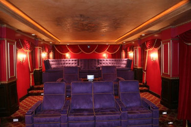 Home theater - carpeted home theater idea in Providence with red walls