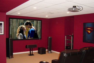 Mid-sized transitional enclosed carpeted home theater photo in Philadelphia with red walls and a projector screen
