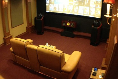 Home theater - carpeted home theater idea in Miami with a media wall