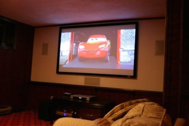 Large enclosed home cinema in Boston with white walls and a projector screen.