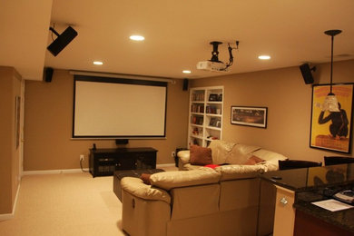 Diseño de cine en casa cerrado de tamaño medio con paredes beige, moqueta y pantalla de proyección