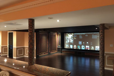 Home theater - mid-sized mediterranean open concept dark wood floor home theater idea in New York with a projector screen and red walls