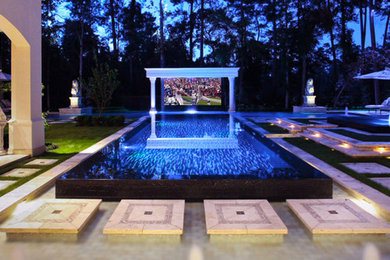 Imagen de cine en casa abierto tropical extra grande con suelo de baldosas de terracota y pantalla de proyección