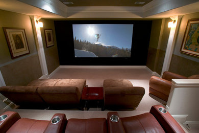 Inspiration for a carpeted home theater remodel in Denver with brown walls and a projector screen