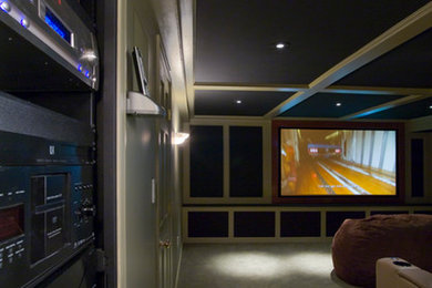 Large enclosed home cinema in Boston with blue walls, carpet and a projector screen.