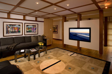 Inspiration for a mid-sized contemporary enclosed light wood floor and beige floor home theater remodel in Philadelphia with multicolored walls and a media wall