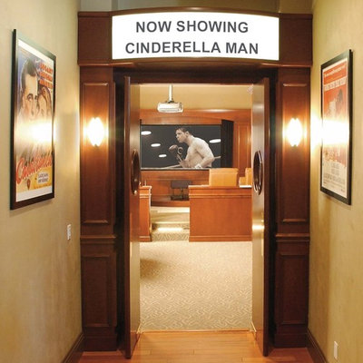 Inspiration for a mid-sized timeless enclosed carpeted home theater remodel in Other with brown walls and a projector screen