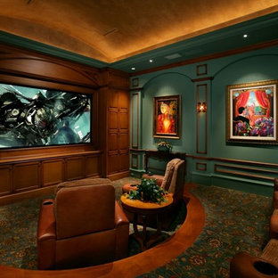 Example of a tuscan enclosed carpeted and multicolored floor home theater design in Miami with green walls and a media wall