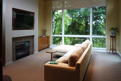 Example of a small minimalist enclosed carpeted home theater design in Other with yellow walls and a wall-mounted tv