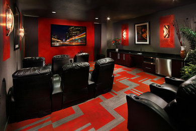 Home theater - mid-sized enclosed carpeted and red floor home theater idea in Phoenix with gray walls and a wall-mounted tv