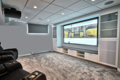 Inspiration for a mid-sized carpeted home theater remodel in Other with gray walls