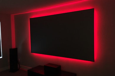 Design ideas for a medium sized urban open plan home cinema in Tampa with a projector screen.