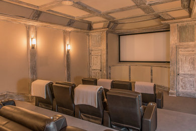 Example of a large trendy enclosed carpeted home theater design in New York with beige walls and a projector screen