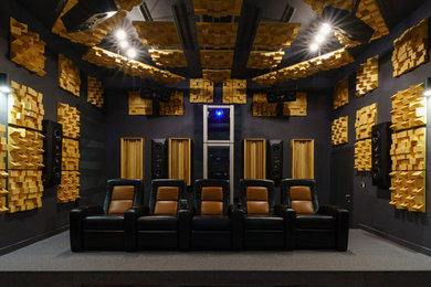 This is an example of a contemporary enclosed home cinema in Los Angeles with black walls, carpet and grey floors.
