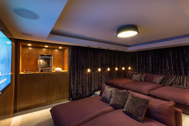 This is an example of a medium sized contemporary enclosed home cinema in Miami with a wall mounted tv.