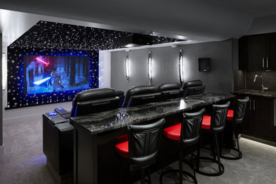 Example of a trendy carpeted and gray floor home theater design in Calgary with gray walls