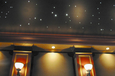 Inspiration for a mid-sized modern enclosed home theater remodel in Raleigh with a projector screen
