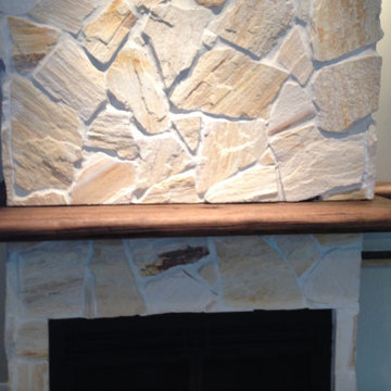 Stone fireplace with custom oak mantle