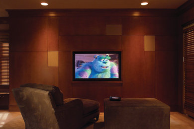 Home theater - mid-sized contemporary open concept carpeted and beige floor home theater idea in Boston with brown walls and a media wall