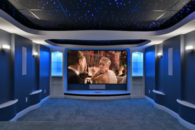 This is an example of a medium sized modern enclosed home cinema in Cleveland with a projector screen.