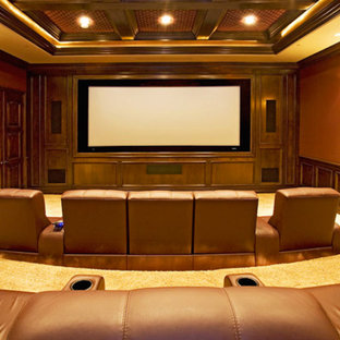 Modelo de cine en casa cerrado, grande, con parades naranjas, moqueta y pantalla de proyección
