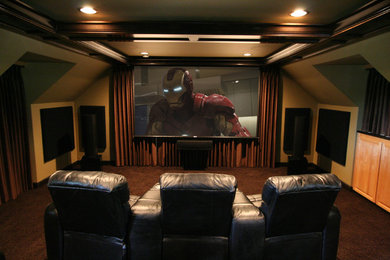 Example of a large classic enclosed carpeted and brown floor home theater design in Seattle with a projector screen