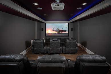 Inspiration for a large transitional laminate floor and brown floor home theater remodel in Atlanta with blue walls